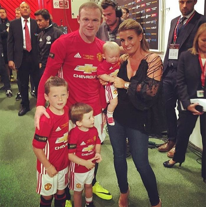 Happily married husband and wife: Wayne Rooney and Coleen with their three children