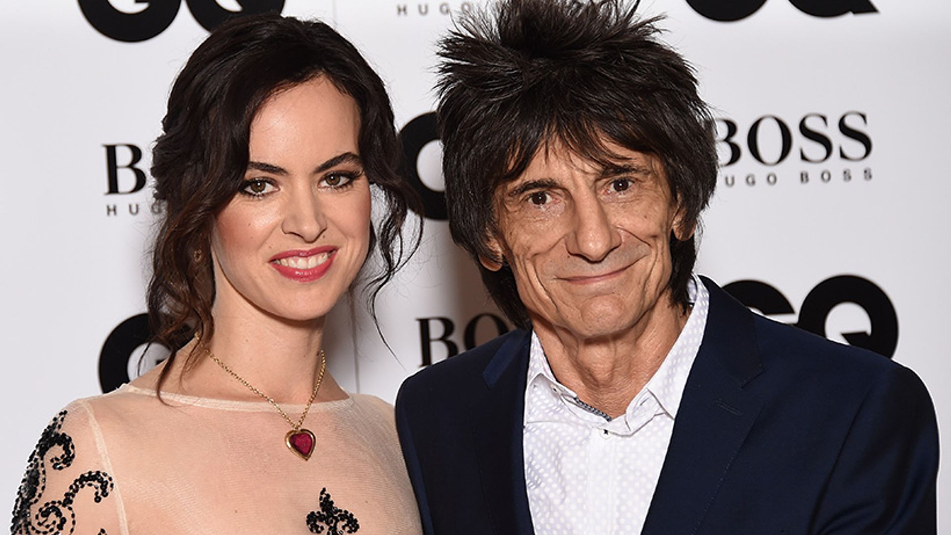 Ronnie Wood poses with twin daughters to mark 70th