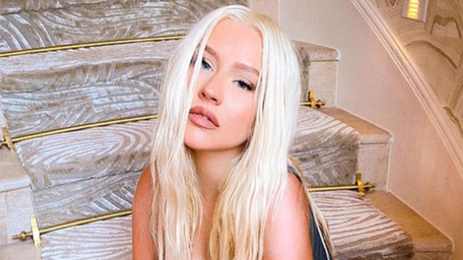 Christina Aguilera causes a stir posing topless in tiny briefs