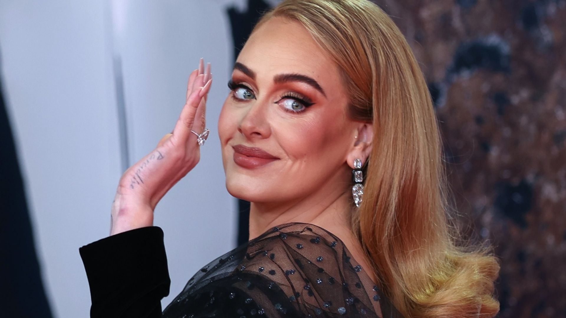 Adele thanks ex-husband in emotional speech as she wear large diamond on ring finger  