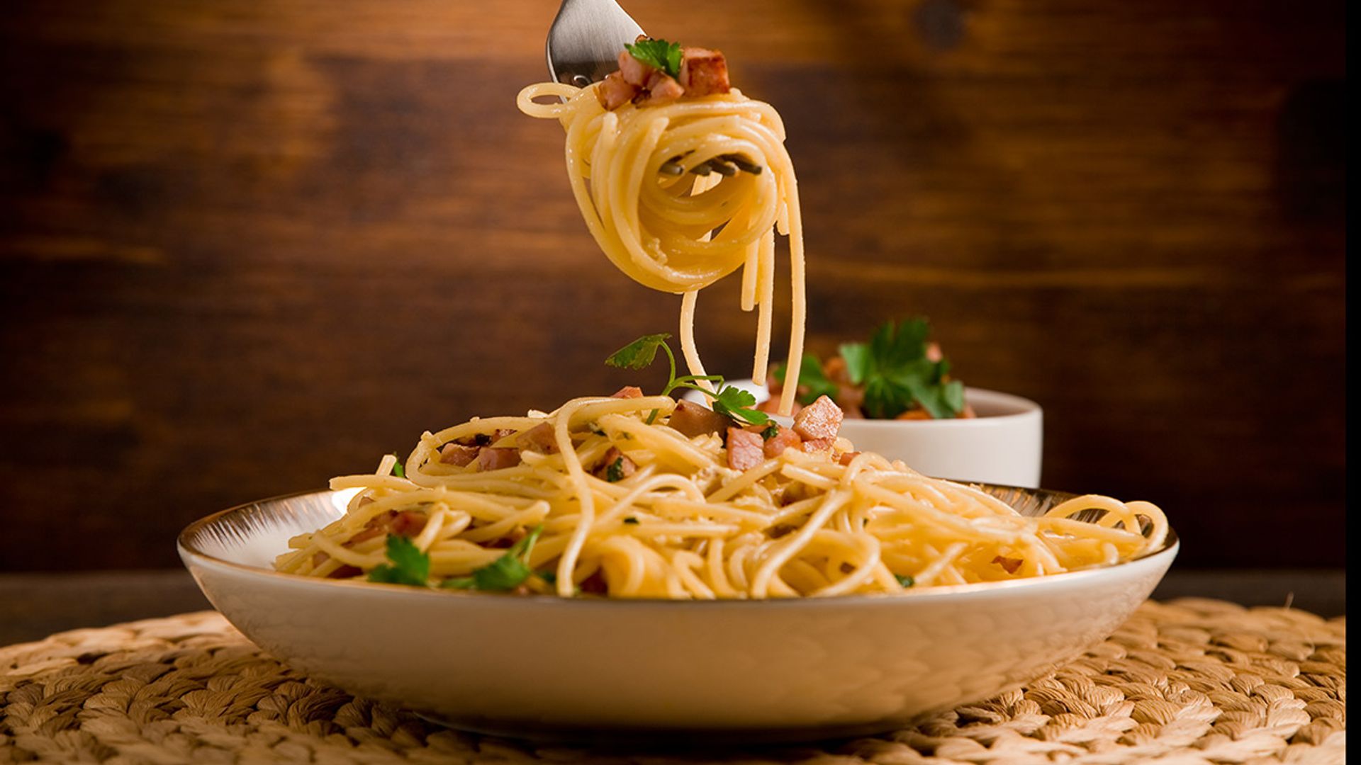 Spoon or no spoon for spaghetti? A top etiquette coach reveals the CORRECT way to eat pasta