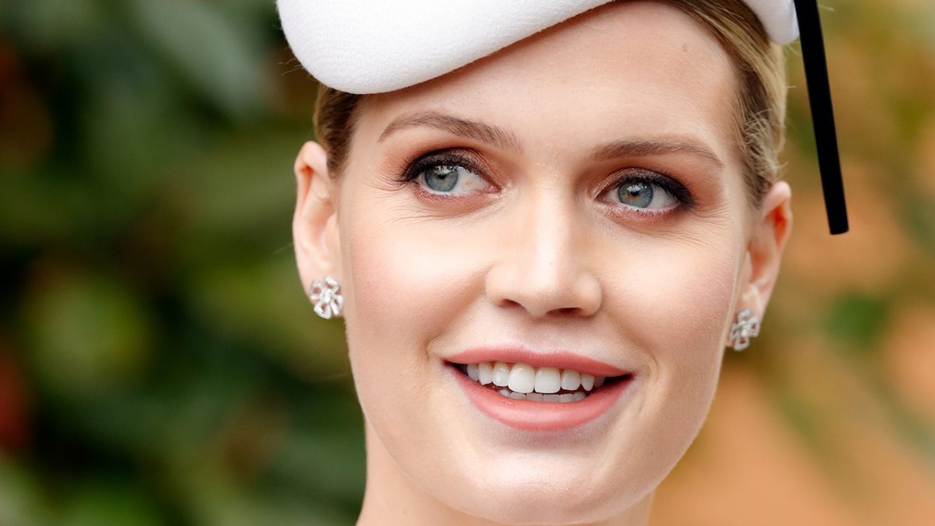 Lady Kitty Spencer wows in a white gown and diamond jewellery as she poses in ultra-grand living room