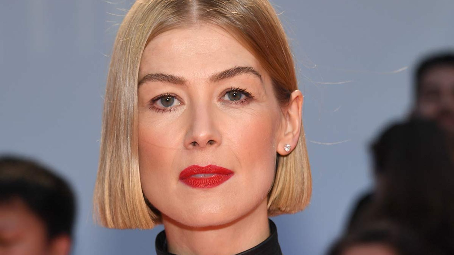 I Care A Lot's Rosamund Pike displays trim waist in dramatic plunging gown