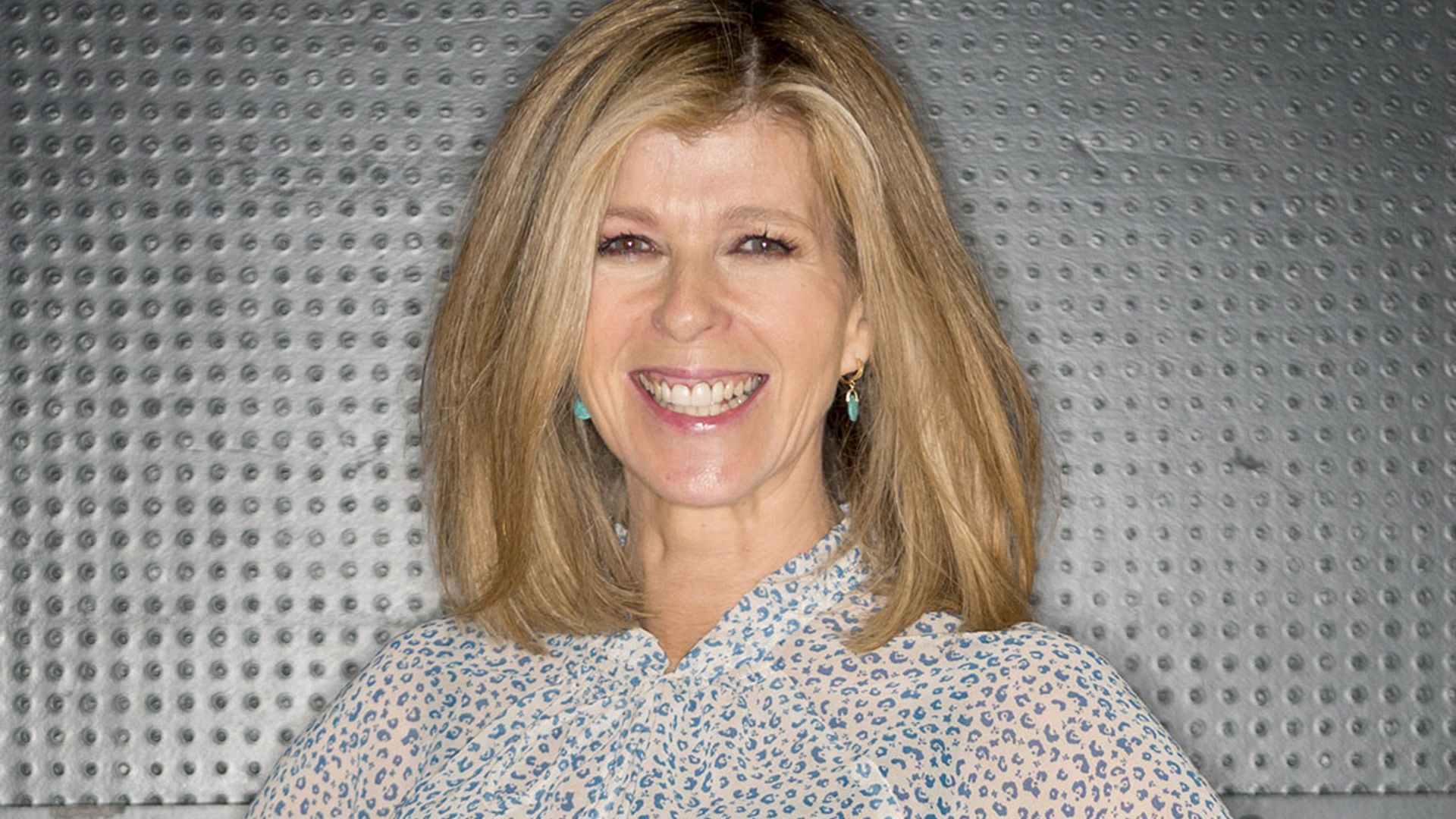 Kate Garraway floors fans in fitted pencil skirt and sheer blouse