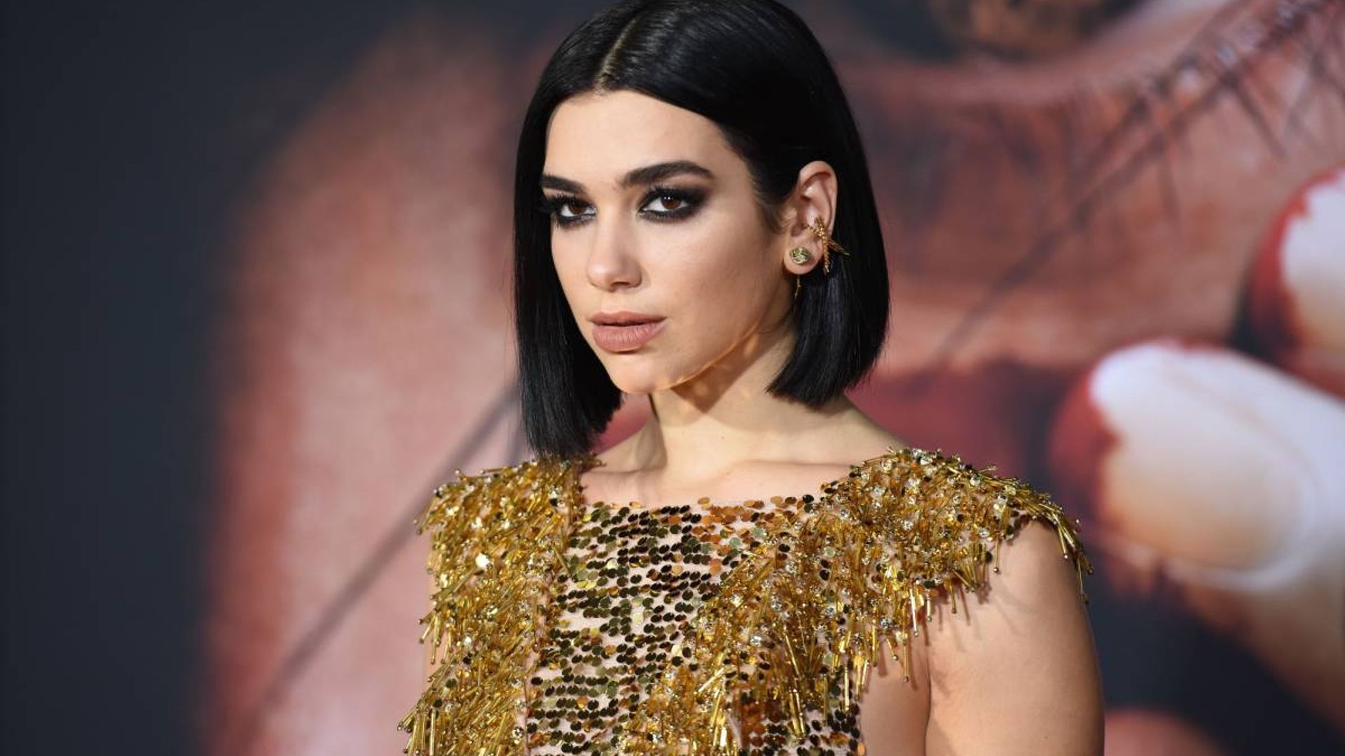 Dua Lipa wows in a strappy black vacation look - and fans are losing it