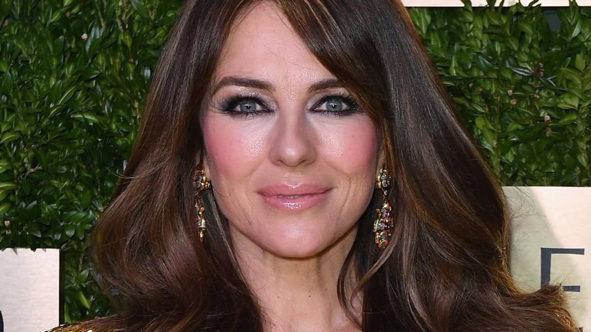 Elizabeth Hurley is the ultimate fashionista in beaded mini dress – and son Damian approves