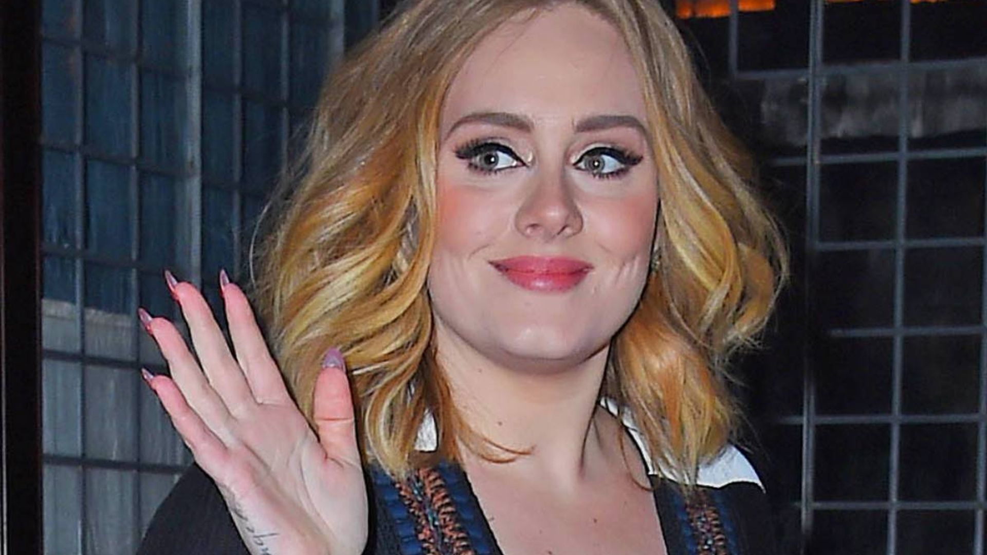 Adele showcases toned legs in leather mini skirt and figure-hugging jacket during jaw-dropping appearance