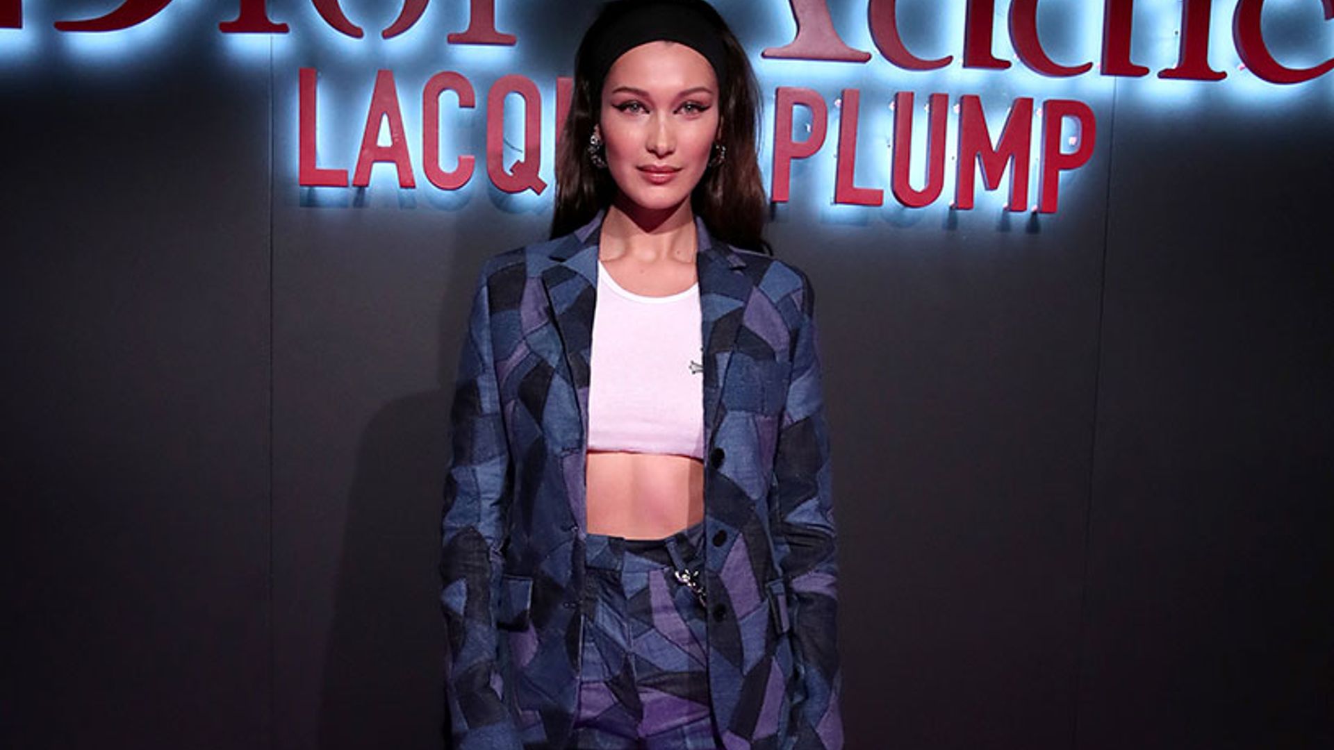 Bella Hadid shows off her killer abs in a denim patchwork suit
