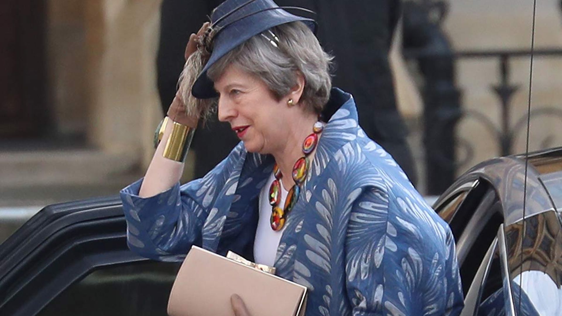 Breezy not Brexit! Theresa May battles with her hat as she mingles with the royal family at the CommonWealth