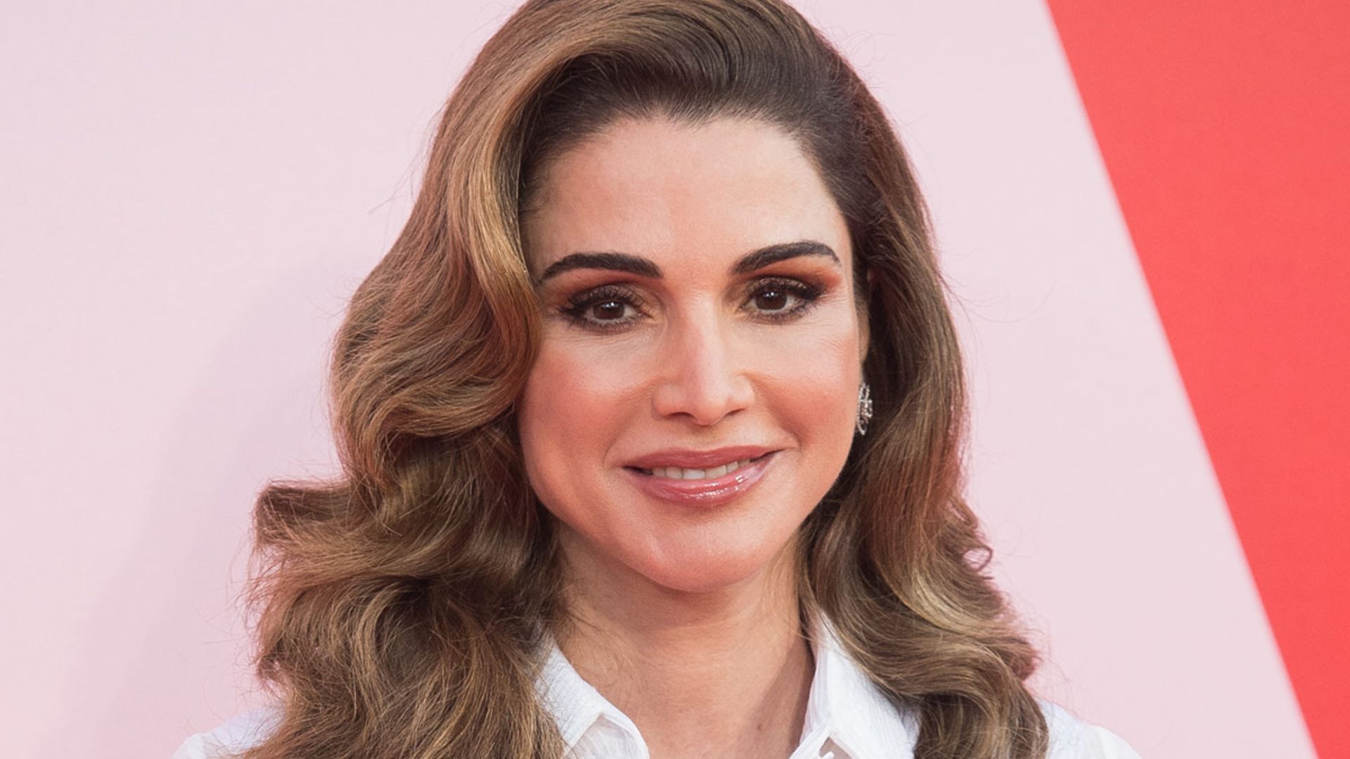 Queen Rania steps out in pink power suit – and looks incredible
