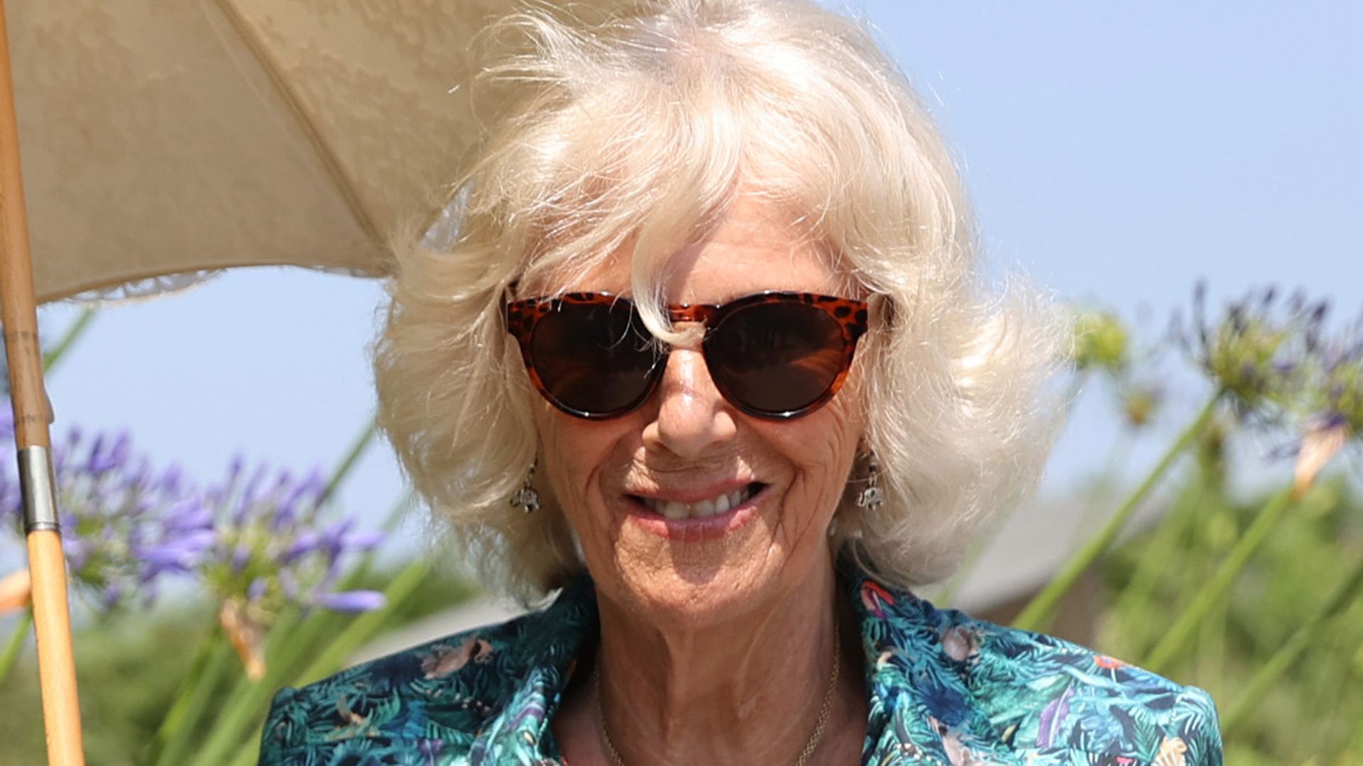 Duchess Camilla looks so chic in silky dress and shades as she steps off the plane