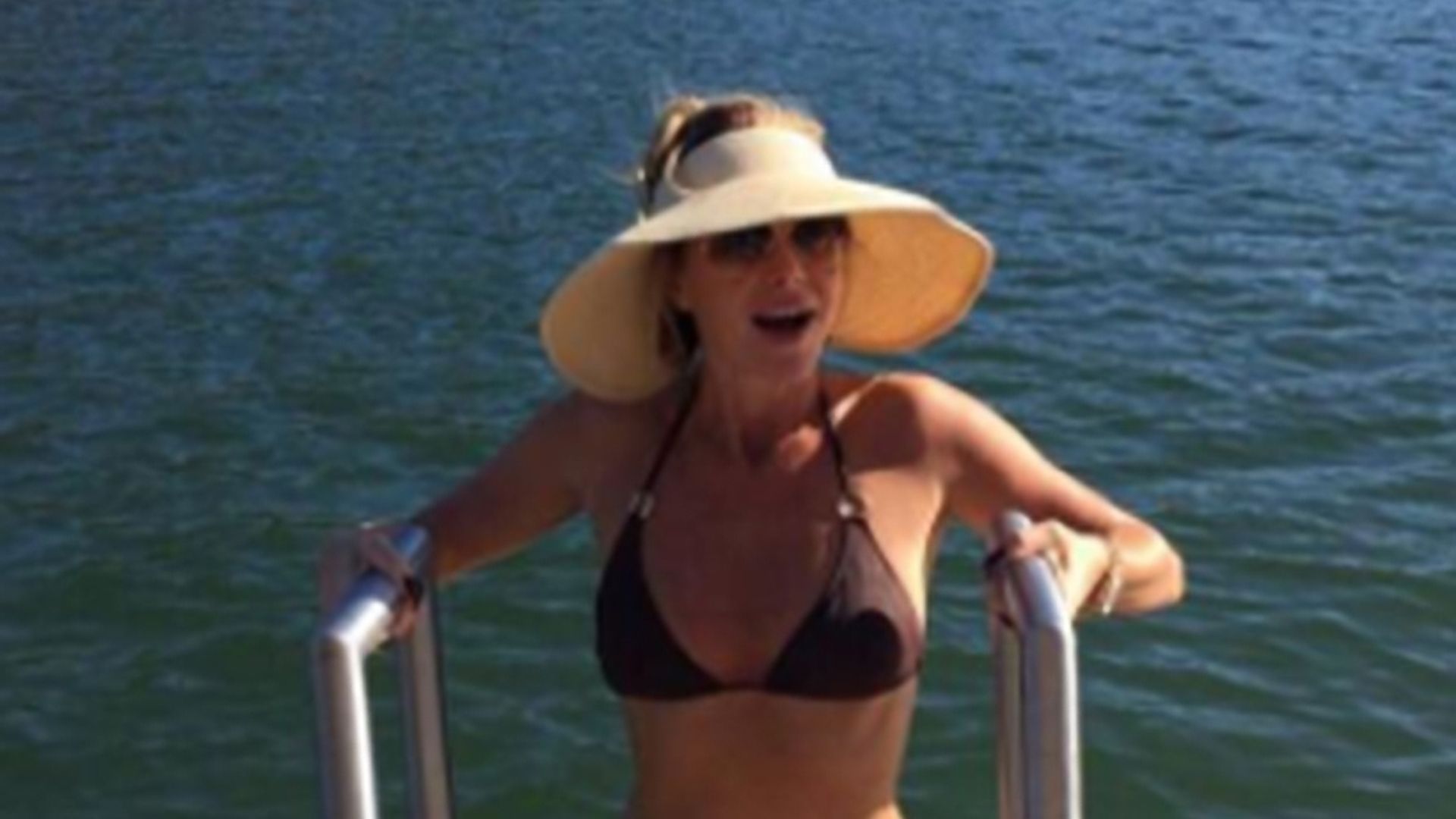 Amanda Holden shows off tiny waist and slim figure in brown bikini