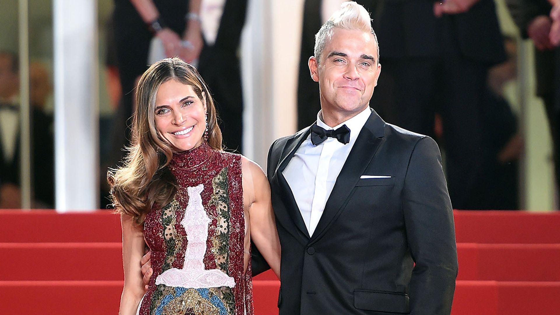 ayda field and robbie williams on red carpet 
