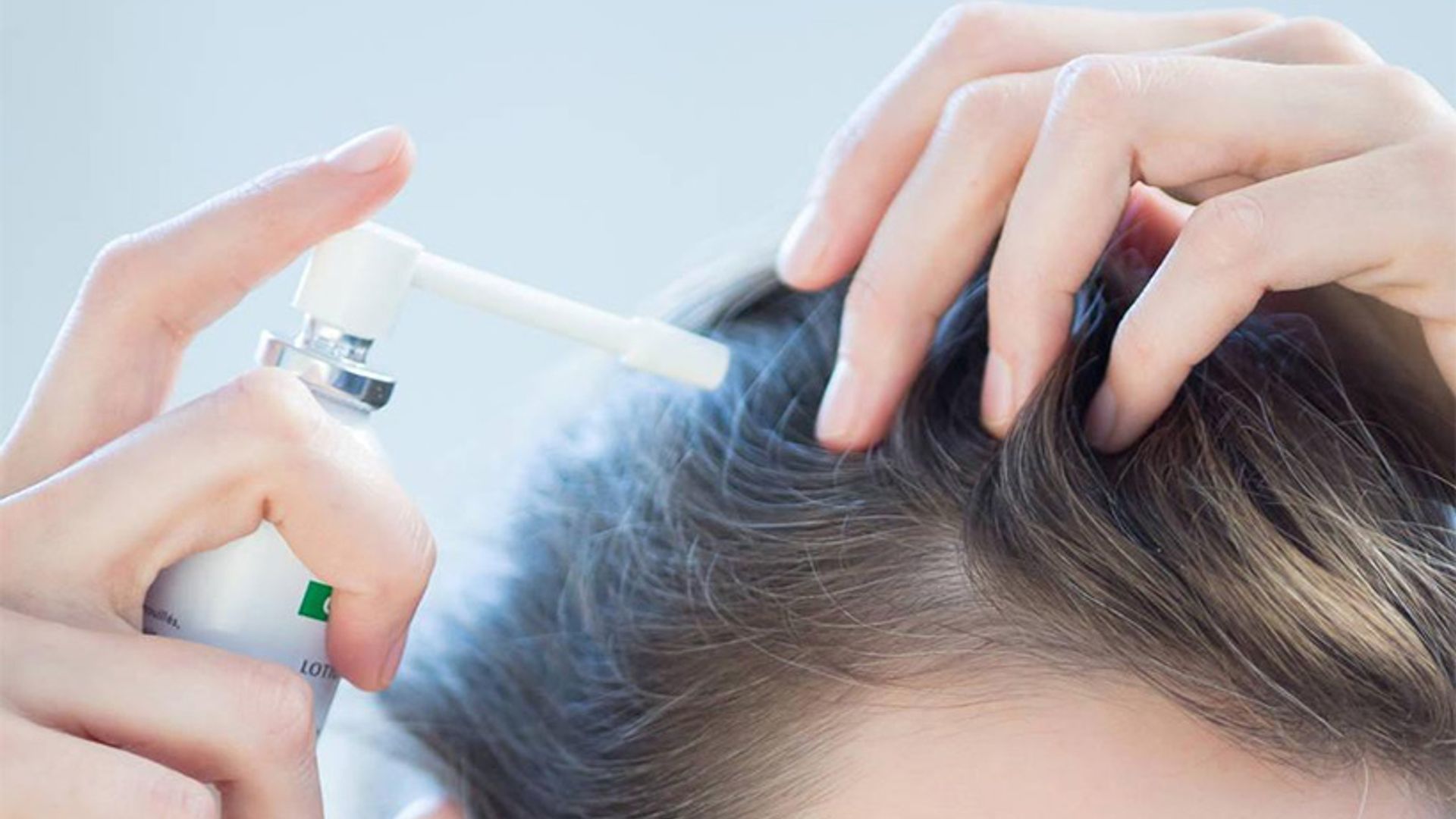 woman-applying-hair-conditioner