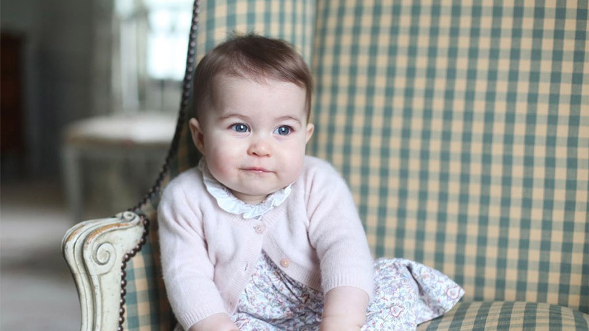 Who designed Prince George and Princess Charlotte's royal birthday portrait outfits?