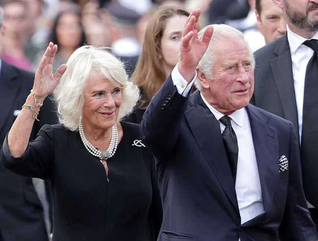 Charles and Camilla waving